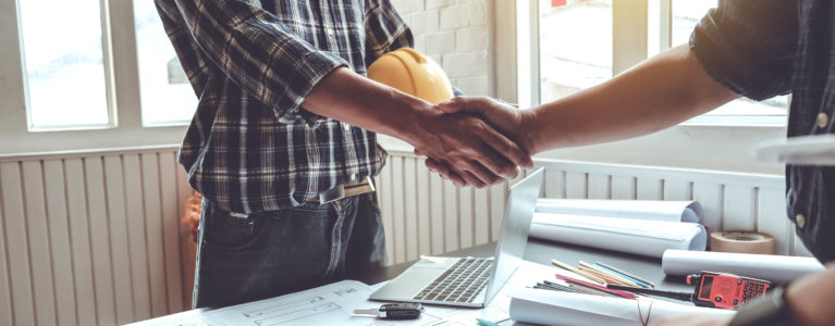 Contractor and subcontractor shaking hands agreement