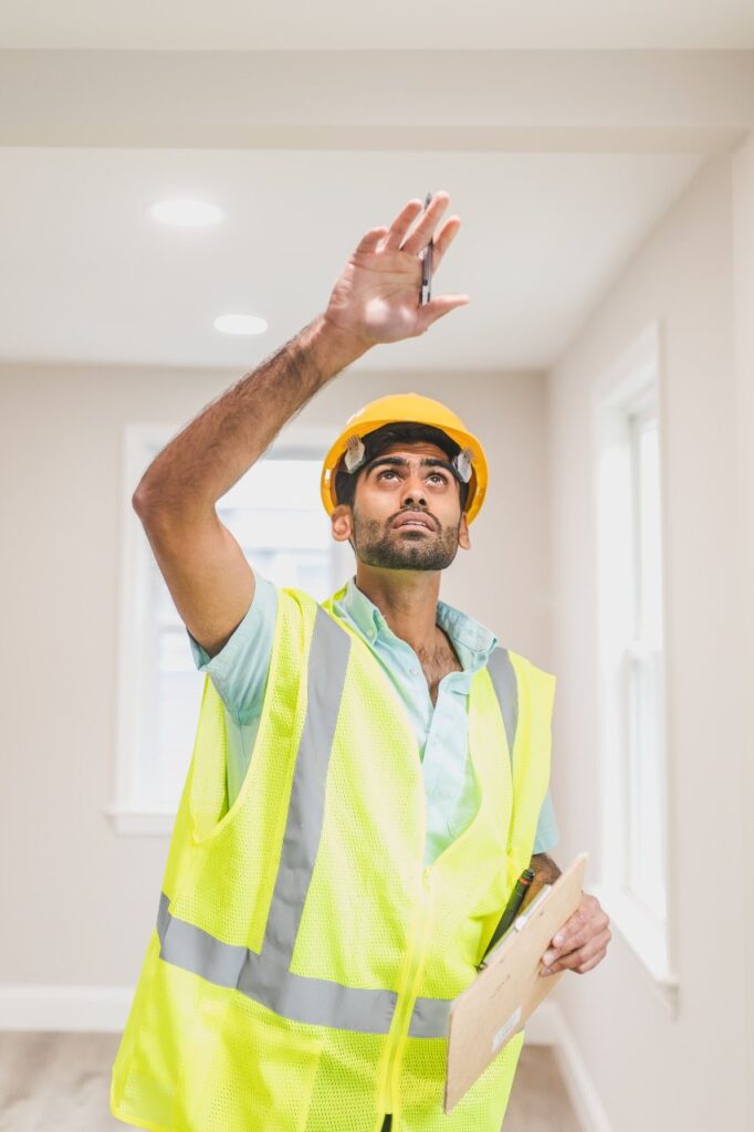 a man with a hard hat inside a house